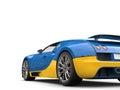 Bright blue and yellow modern super sports car - tail view cut shot Royalty Free Stock Photo