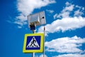Bright blue and yellow pedestrian crosswalk sign with traffic warning. Powered by solar energy with its own solar panel Royalty Free Stock Photo