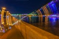 Bright blurred colorful background of night city with bridge. Neon bright reflections, light trails, multicolored bokeh, modern Royalty Free Stock Photo