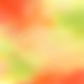 Bright blurred yellow-green background interspersed with red-orange, a beautiful combination of warm colors, transition, gradient