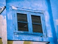 Colourful Blue Window With Shutters On A Street Art Wall