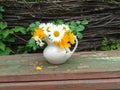 Rustic bouquet with chamomiles and yellow flowers.