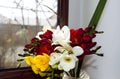 Bright bouquet of odorous freesia on a windowsill