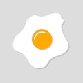 Bright broken fried egg with shadow