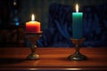 a bright candle and a snuffed out candle side by side on a table