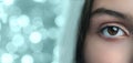 Bright and captivating eye with a unique reflection in a blurred background of sparkling lights Royalty Free Stock Photo