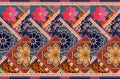 Bright carpet in patchwork style with flowers, ornamental border and mandala. Endless pattern
