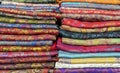 Bright cashmere shawls in the bazaar. Background with oriental shawls