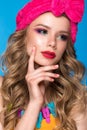 Bright cheerful girl in home hat, colorful make-up, curls and pink manicure. Beauty face.