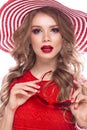 Bright cheerful girl in summer hat, colorful make-up, curls and pink manicure. Beauty face. Royalty Free Stock Photo