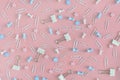 Bright pattern. Stationery chaotically scattered on a pink background. Staples, asterisks and buttons are in disarray. Royalty Free Stock Photo