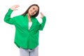 bright cheerful young brown-haired female model with brown eyes in a green shirt posing on a white background with copy Royalty Free Stock Photo