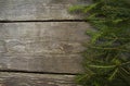 Bright christmas background frame with a copy space with fir branches with a wooden table