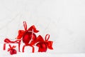 Bright christmas background - heap festive white gift boxes, shine red balls with red satin ribbons in decorative fairy winter.