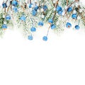 Bright Christmas card composition with blue berries and Xmas tree branch isolated on white background. Winter decorations border Royalty Free Stock Photo