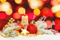 Bright Christmas composition with abstract bokeh light background, green fir branch, gold garland, red baubles, holly berries Royalty Free Stock Photo