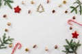 Bright Christmas frame of spruce, brown and gold Christmas decorations, mints on a white background. Copy space. Winter holidays Royalty Free Stock Photo