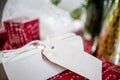 Bright Christmas presents in holiday wrappers with tags and ribbon folded under the Christmas tree Royalty Free Stock Photo