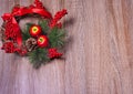 Bright Christmas wreath on a wooden background. Royalty Free Stock Photo