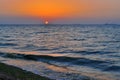 Bright circle of sun yellow pink orange red dawn at sea with waves, sun Royalty Free Stock Photo