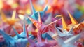 A bright close-up of Origami paper crane birds, a Japanese practice that involves folding intricately folded paper into a variety