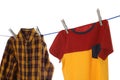 Bright clothes drying on washing line against white background Royalty Free Stock Photo