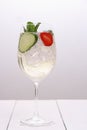 Bright cocktail with cucumber, strawberry in wine glass Royalty Free Stock Photo