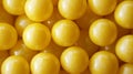 A bright collection of yellow balls densely arranged, creating a captivating texture and color contrast