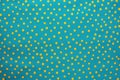 bright color contrast of yellow dots on a teal textile