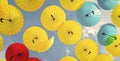 Bright color umbrellas hanging on blue sky background bottom-up Royalty Free Stock Photo