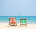 Bright color wooden beach chairs on island tropical beach Royalty Free Stock Photo