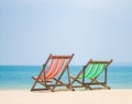 Bright color wooden beach chairs on island tropical beach