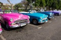 Bright Colored Classic cars in a parking lot in Havana Cuba