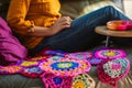 bright colored crochet work on an armrest table beside a relaxing crafter