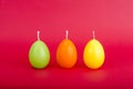 Bright colored decorative candles in shape of eggs.