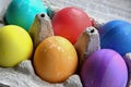 Bright colored Easter eggs in an egg carton