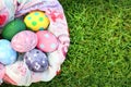 Bright colored eggs and beautiful cloth on grass on Easter day. Royalty Free Stock Photo