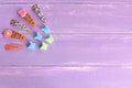 Bright colored hair clips for girls on lilac wooden background with copy space for text. Girl fashion background Royalty Free Stock Photo