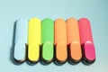 Bright colored markers for highlighting text on a blue background, colored felt-tip pens for drawing