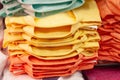 Bright colored shirts are stacked in a shop window. Size range, convenience of purchase. Royalty Free Stock Photo