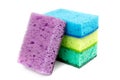 Bright colored sponges for washing dishes, cleaning the bathroom and other household needs are located one above the other. Royalty Free Stock Photo