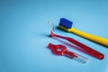 bright colored toothbrush with interdental orthodontic brush on blue background with copy space, close up. Oral hygiene Royalty Free Stock Photo