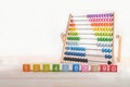 Bright colored wooden bricks with numbers and abacus toy with copy space, Numeral cubes with numbers 1, 2, 3, 4, 5, 6, 7, 8, 9 and
