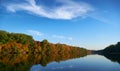 Bright colorful autumn forest landscape, trees near river and blue sky Royalty Free Stock Photo