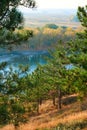 Bright colorful autumn forest landscape, trees near river and blue sky, view from high hill Royalty Free Stock Photo