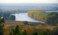 Bright colorful autumn forest landscape, trees near river and blue sky, view from high hill Royalty Free Stock Photo