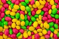 Bright colorful background lots of sweets pink green yellow multi-colored dragees base festive design