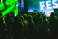 Bright colorful background with the silhouettes dancing young people during the performance favorite musician.