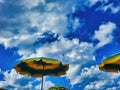 Bright colorful beach umbrella on sunny blue sky day. Multicolored beach umbrella under blue sky on sunny cloudless day. Summer Royalty Free Stock Photo