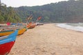 Bright colorful boats with flags for catching fish stood on the shore of the Indian Ocean. India, Goa